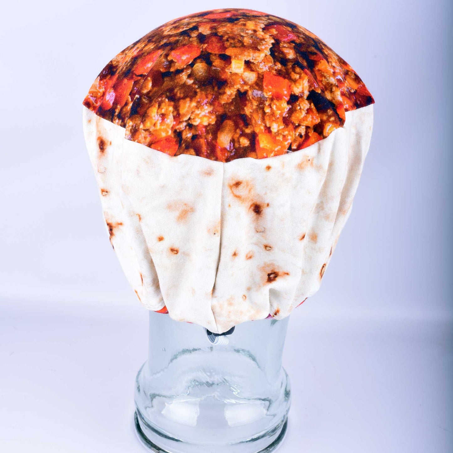 Rear view of a handmade food-themed scrub cap showing the encased elastic and high-quality adjustable toggle for a customizable, stay-put fit.