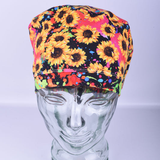 Front view of a full-coverage medical scrub hat with an exclusive yellow sunflower print, highlighting the spacious fit for long hair or buns.