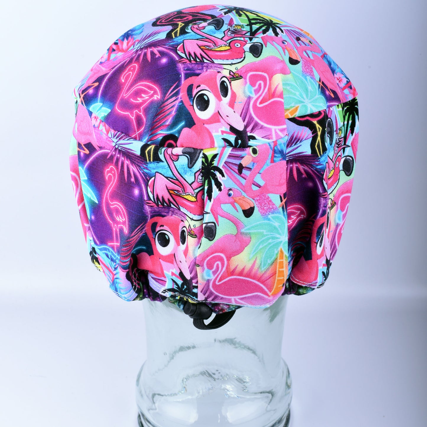 Close-up of the adjustable cord lock toggle and encased elastic on a handmade scrub cap for a customizable, non-slip fit.