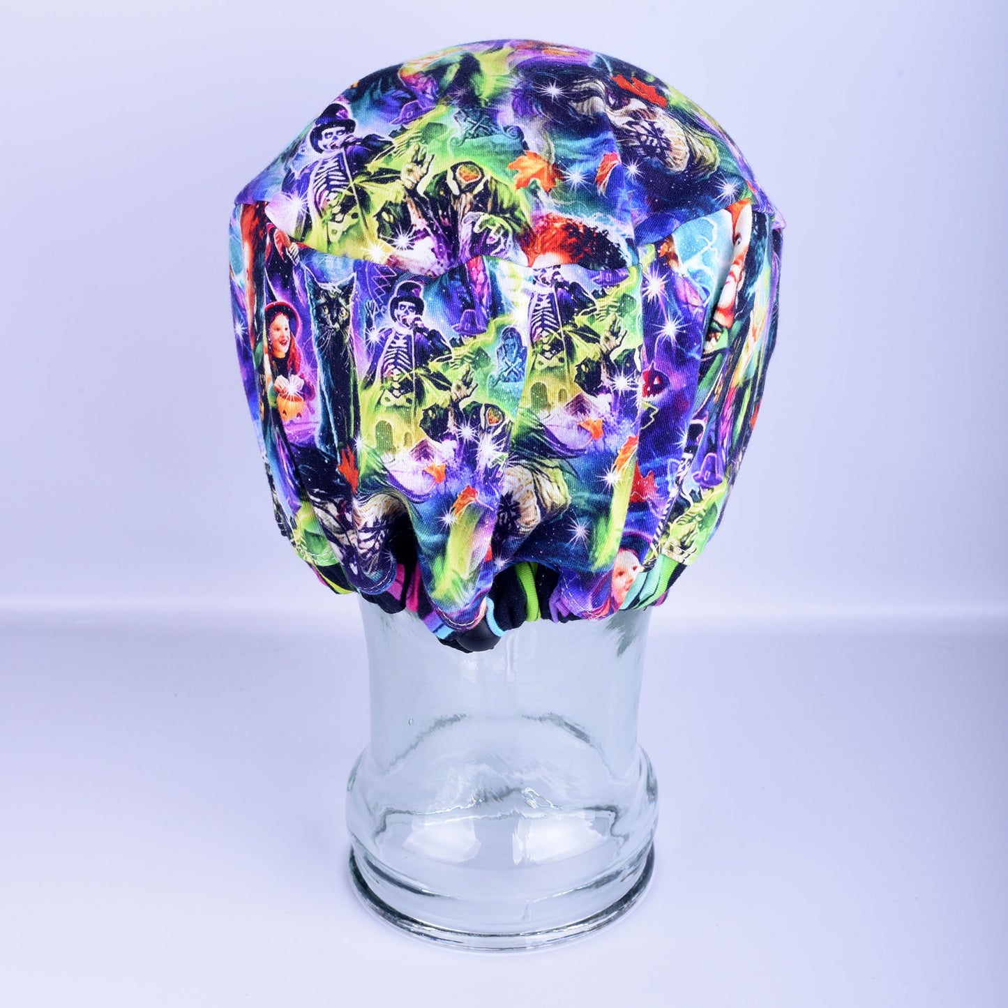 Back view of a full coverage Euro-style scrub cap showing the adjustable cord lock toggle drawstring and elastic gather over hair.