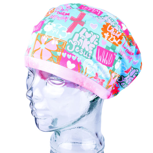 A multicolor scrub cap with a religious and pop-culture graphic print, displayed on a clear glass mannequin head against a white background.
