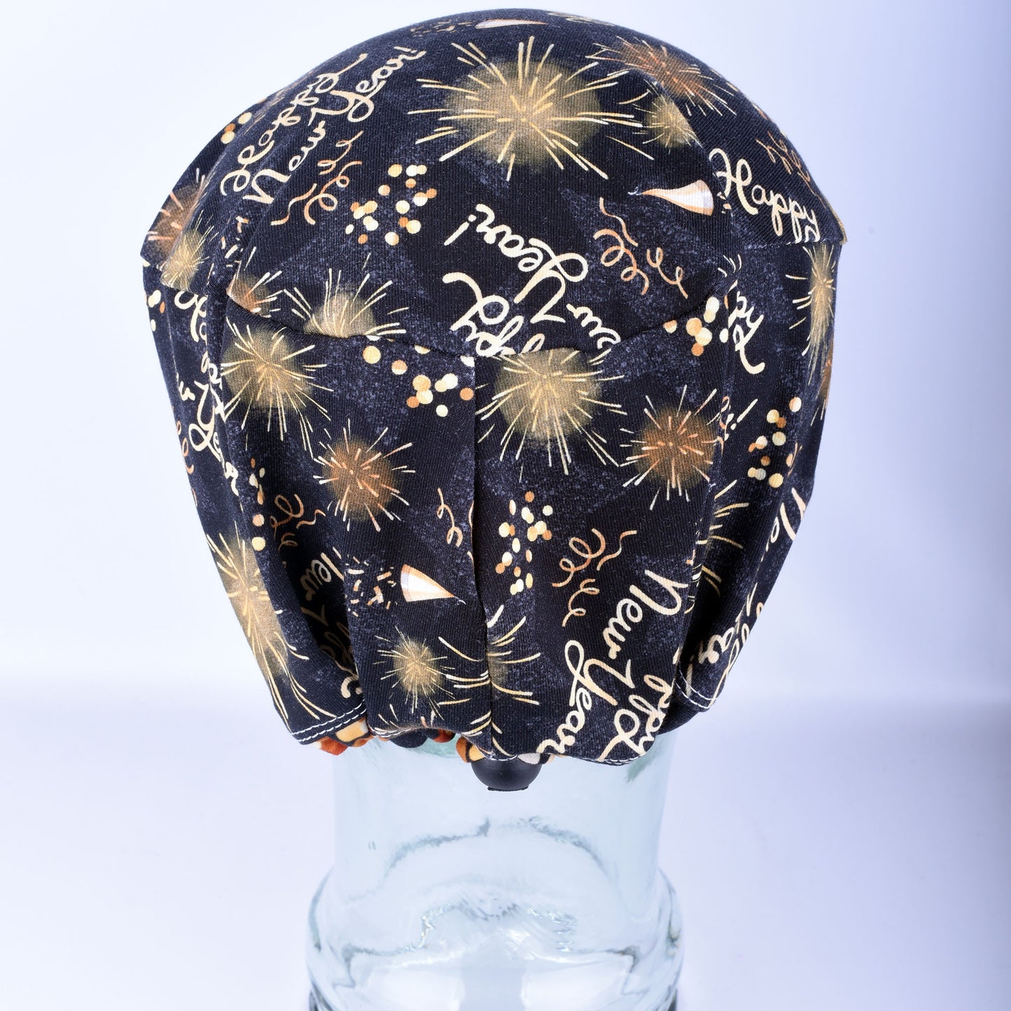 Back view of the New Year Celebration scrub cap highlighting the adjustable cord lock toggle and encased elastic.