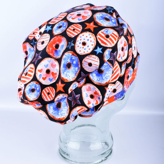 Side profile of a Euro-style scrub cap with an adjustable toggle cord lock for a customizable fit, featuring a red and blue donut design.
