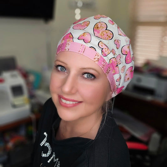 Healthcare professional wearing a pink heart-patterned full coverage scrub cap, demonstrating a secure and comfortable fit.