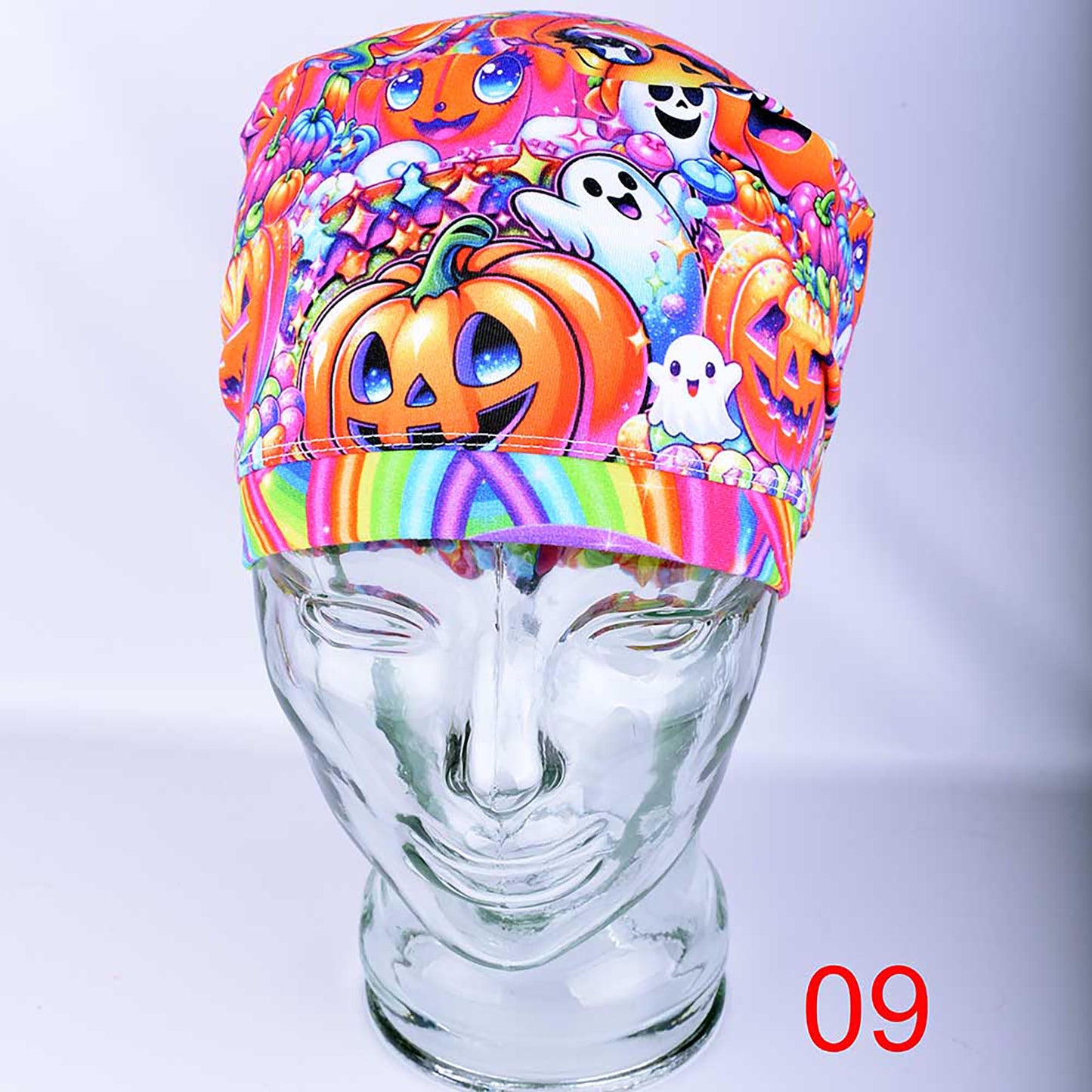 Close-up view of the Rainbow Pumpkins scrub cap in Design 09 styling, showcasing the bright neon-colored autumn pumpkin pattern.