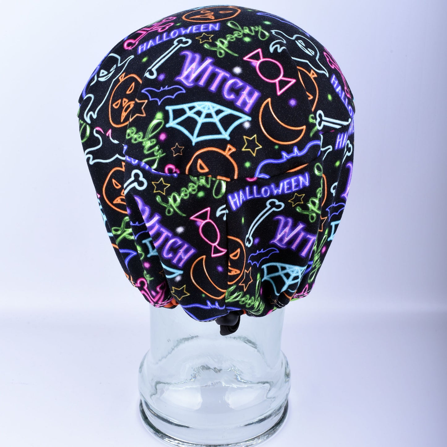Back view of a medical scrub hat displaying the adjustable cord lock toggle and encased elastic closure.