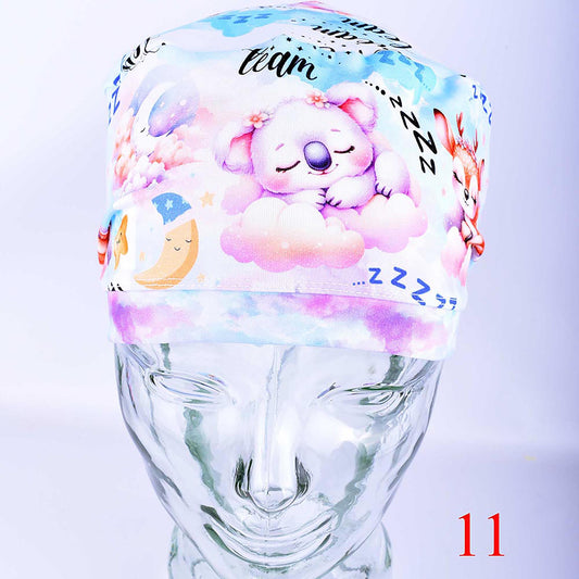 Close-up of the front of a Sweet Dreams scrub hat showing the high-quality cotton-elastane knit fabric and vibrant anesthesia-themed pattern with "Zzz" lettering.