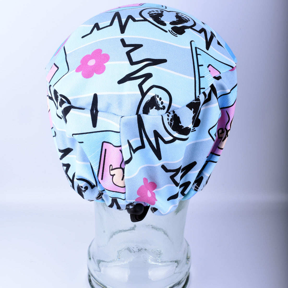 Close-up of the adjustable cord lock toggle and elastic back on a handmade sonographer scrub hat.