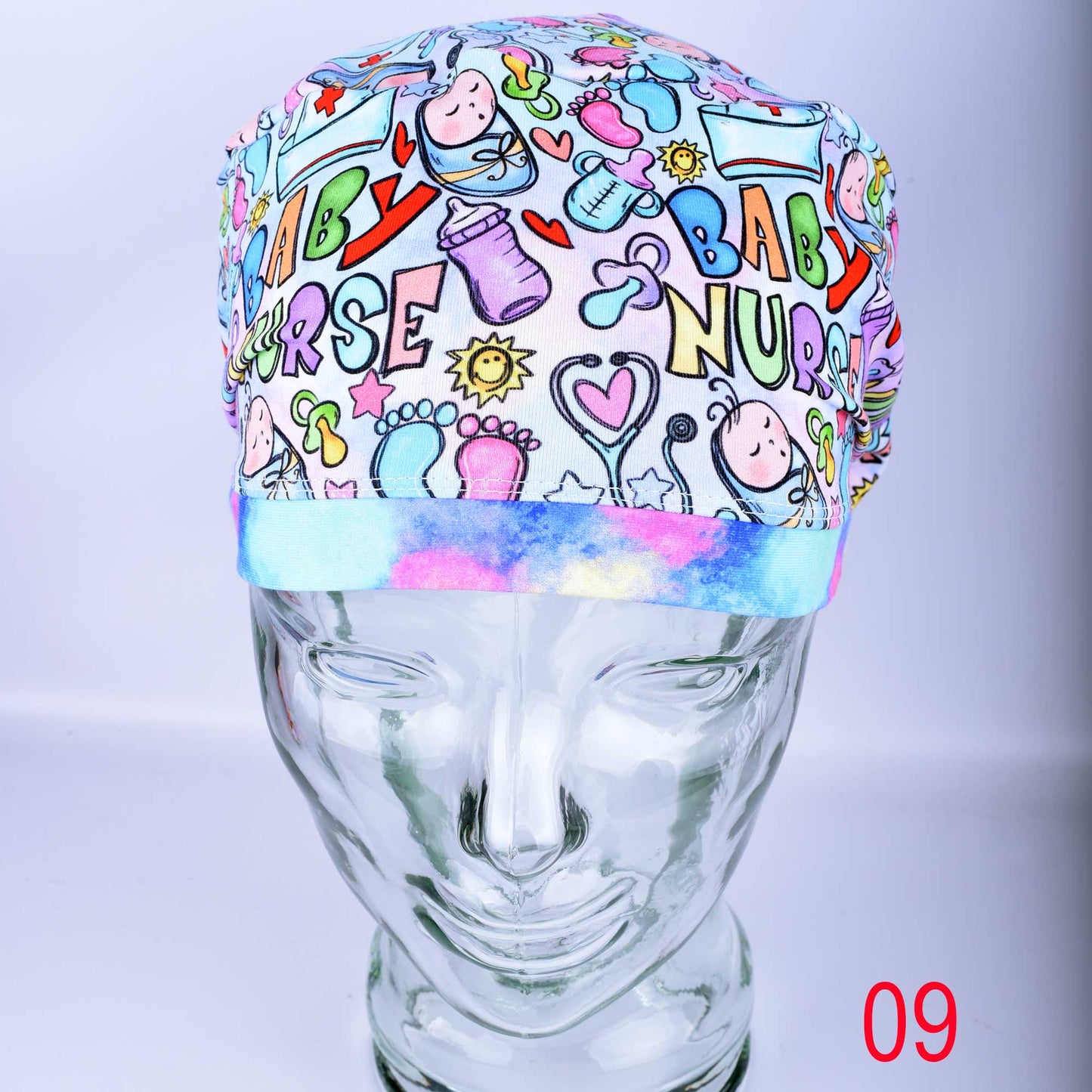 Colorful 'Baby Nurse' themed scrub cap on a mannequin head against a light gray background