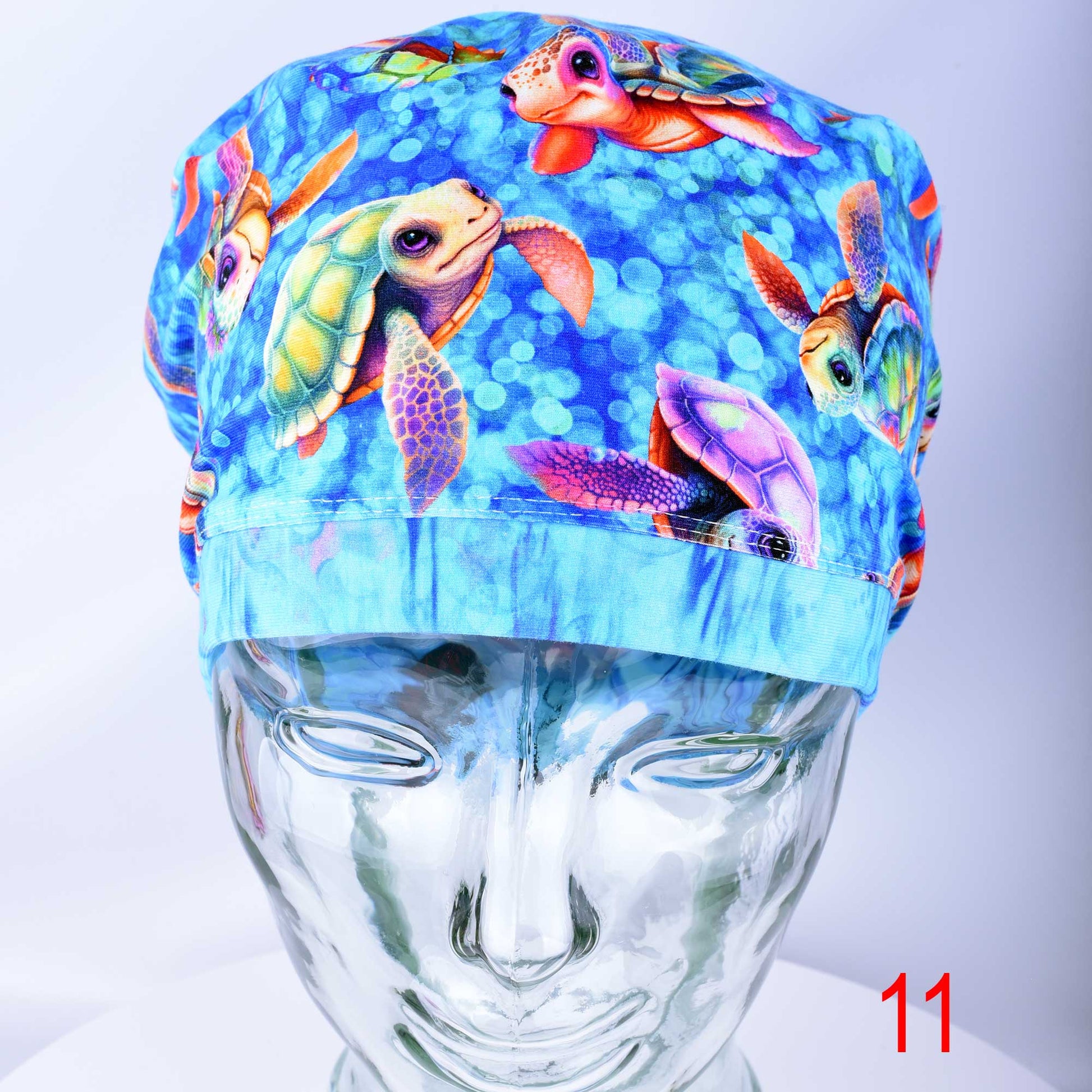 Detailed view of the exclusive, premium stretchy cotton-elastane fabric with an in-house designed whimsical baby turtle print used for scrub caps.