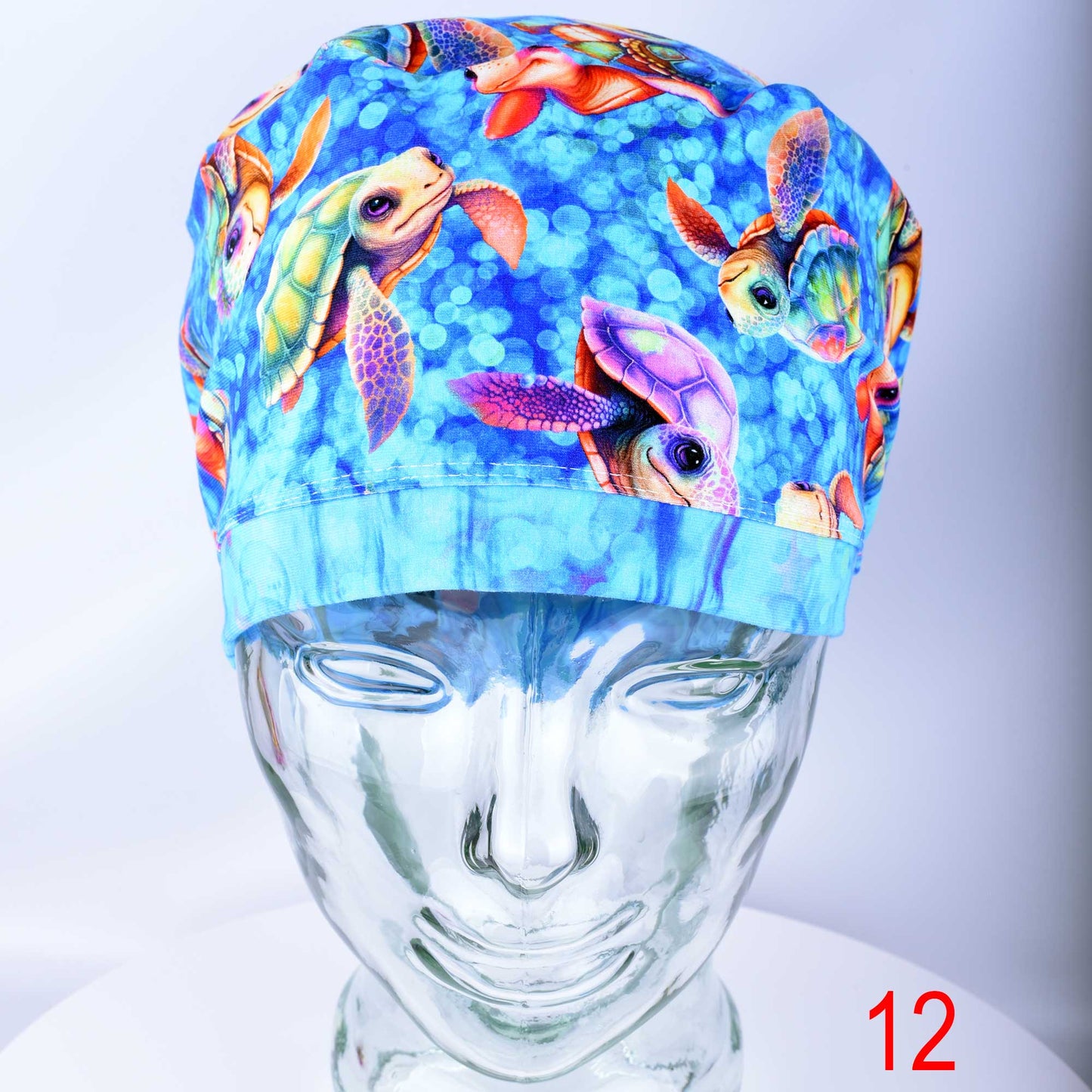 Detailed view of the exclusive, premium stretchy cotton-elastane fabric with an in-house designed whimsical baby turtle print used for scrub caps.