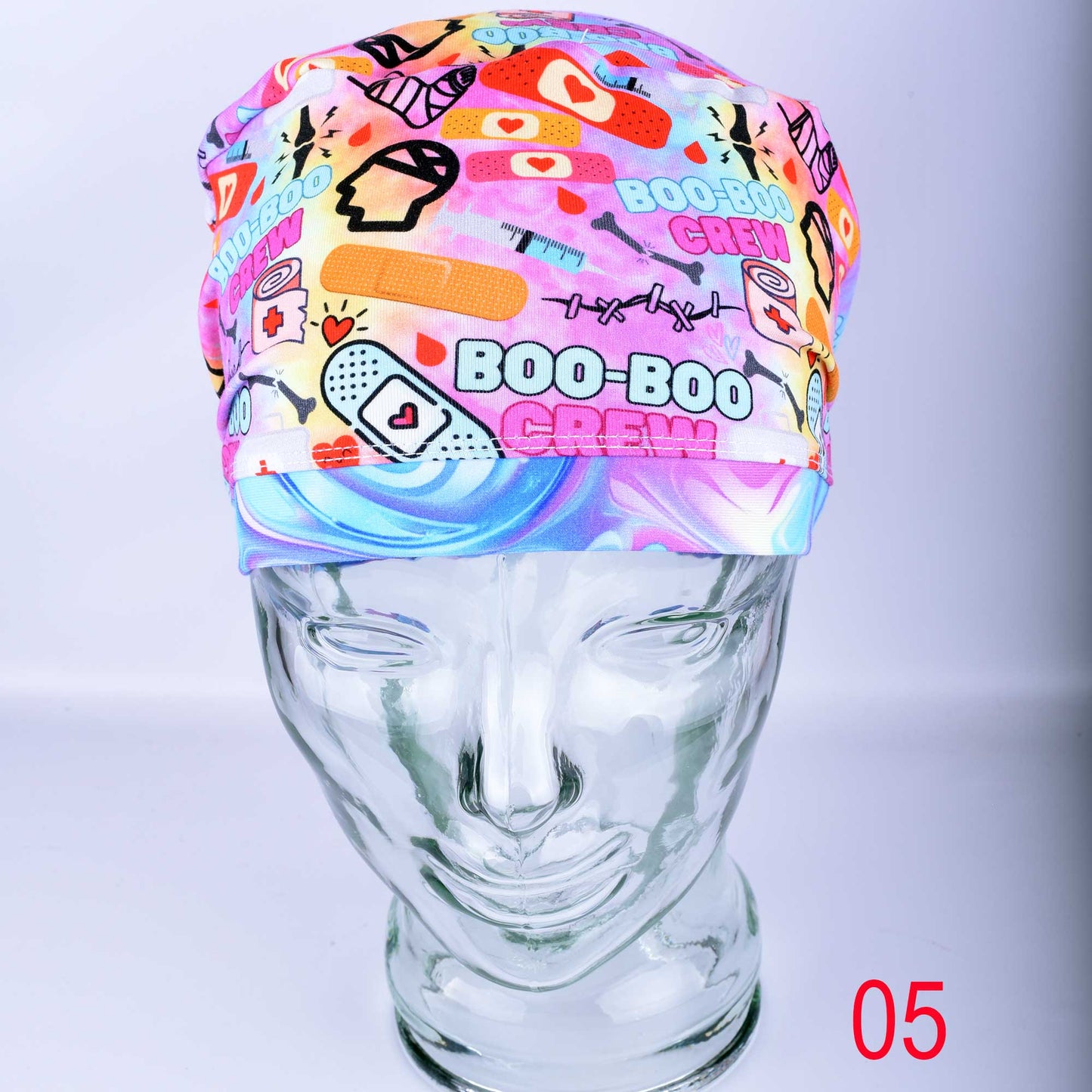 Close-up of Boo Boo Crew scrub cap featuring a playful medical-themed print on soft, stretchy fabric.