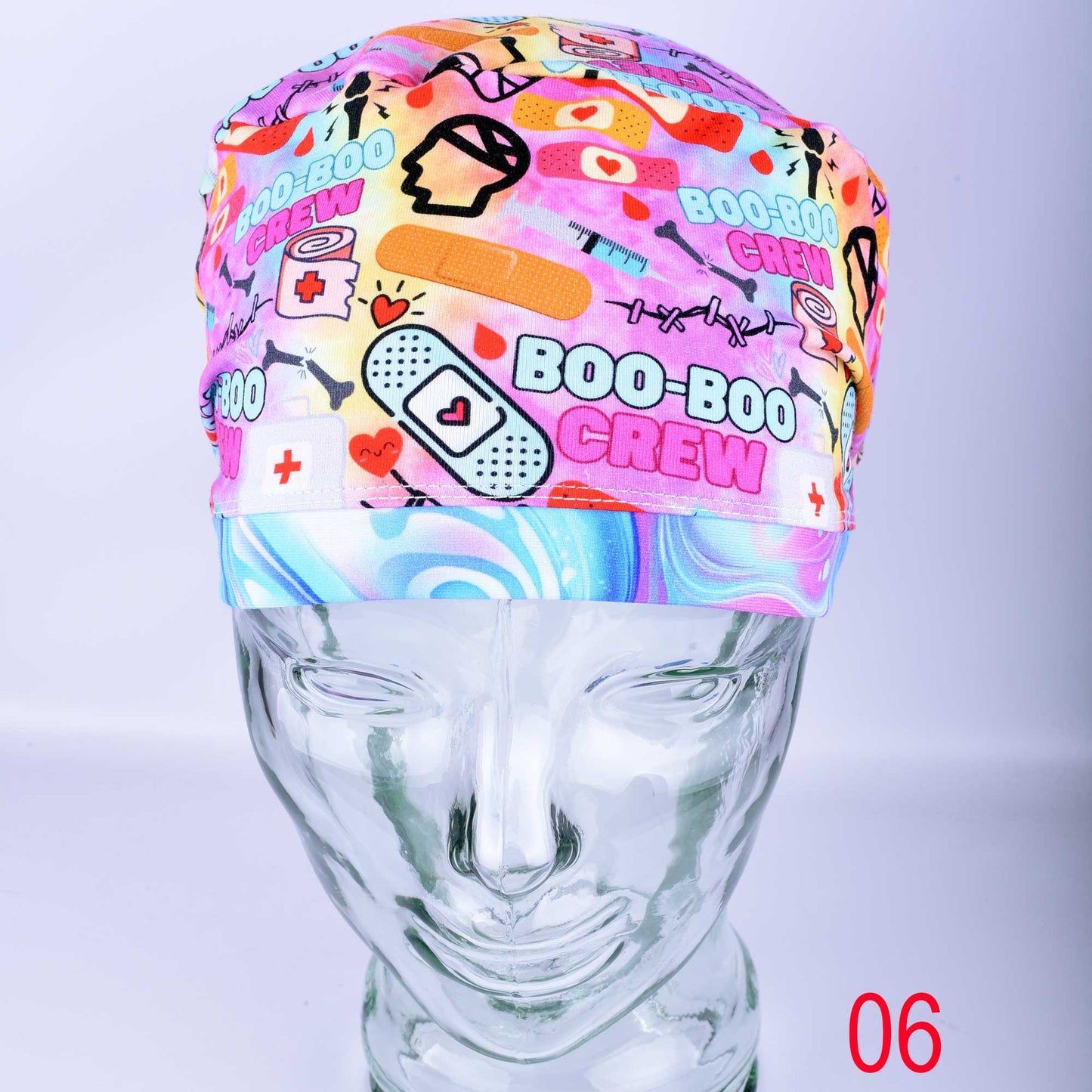 Close-up of Boo Boo Crew scrub cap featuring a playful medical-themed print on soft, stretchy fabric.
