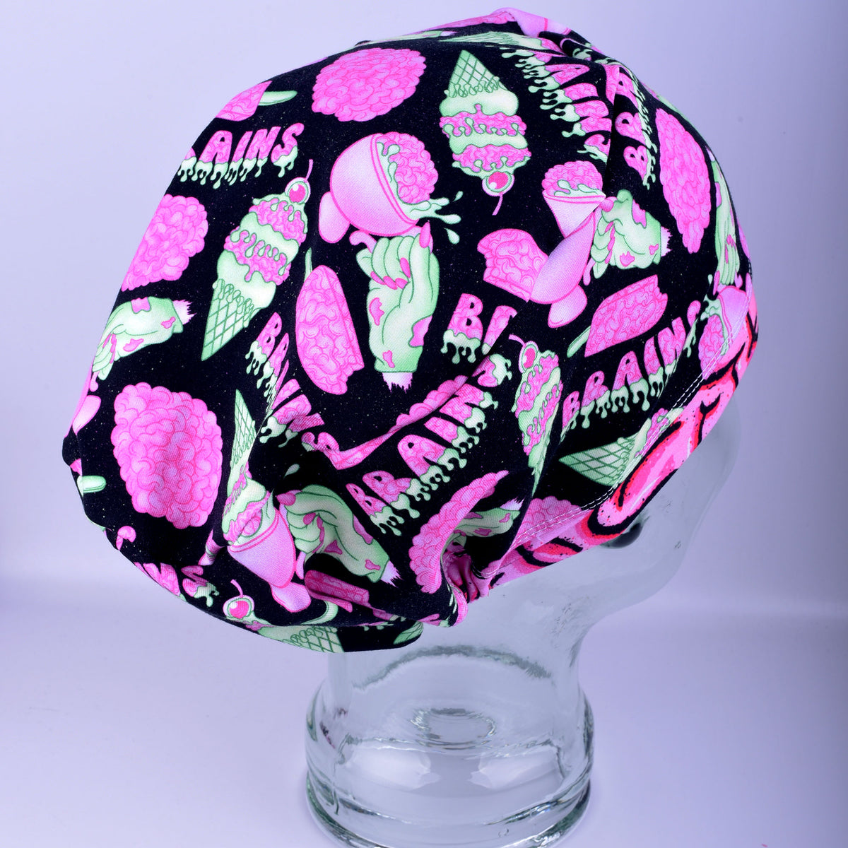 Overhead angle of a full-coverage surgical cap made with a stretchy cotton-blend fabric in a brain motif design.