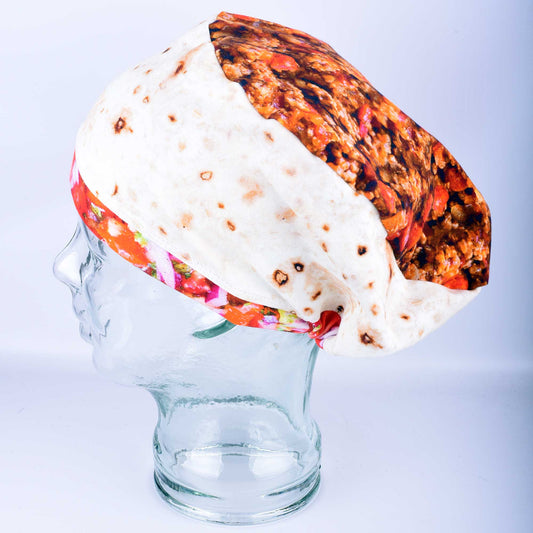 Full coverage scrub cap featuring a vibrant burrito and taco pattern on a mannequin head, showing the secure fit and adjustable cord lock toggle at the back.