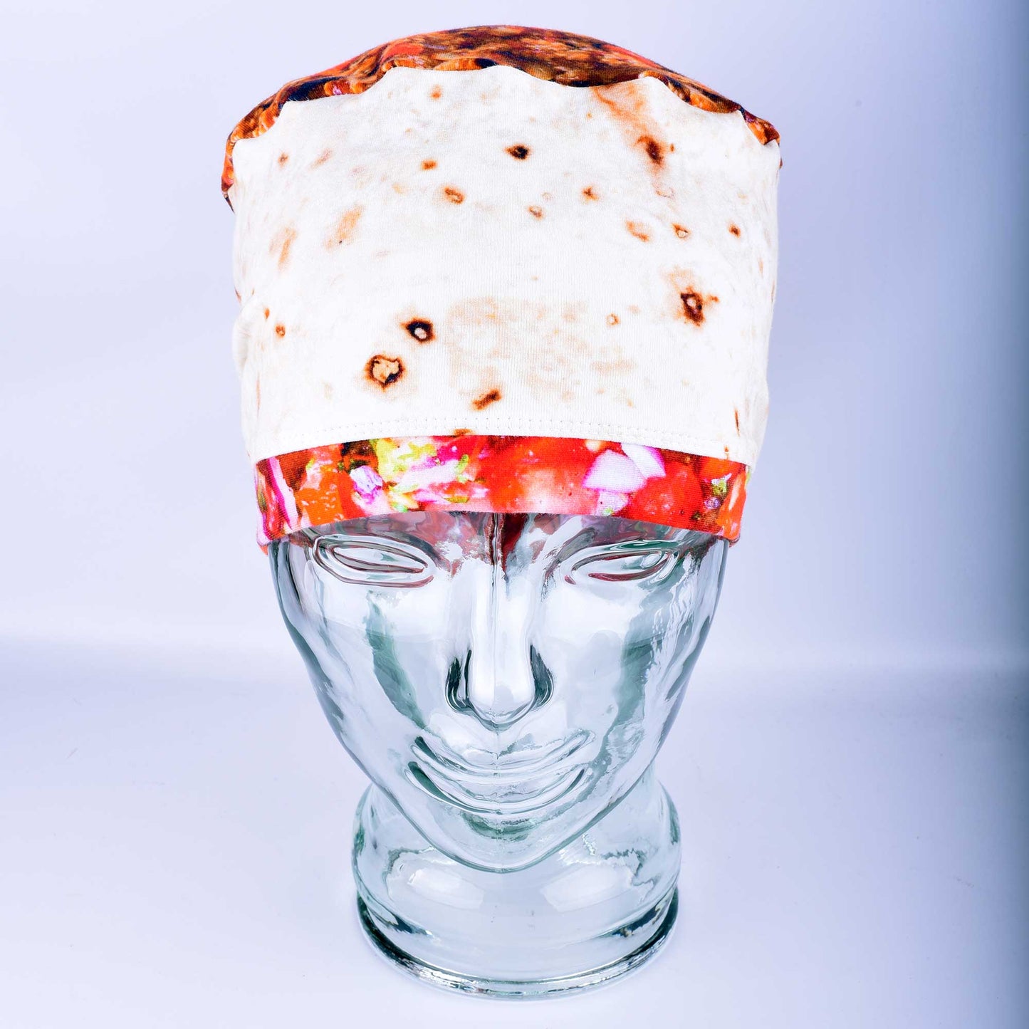 Front view of a breathable cotton scrub cap with a playful "tortilla" style print featuring illustrated burritos and tacos for healthcare professionals.