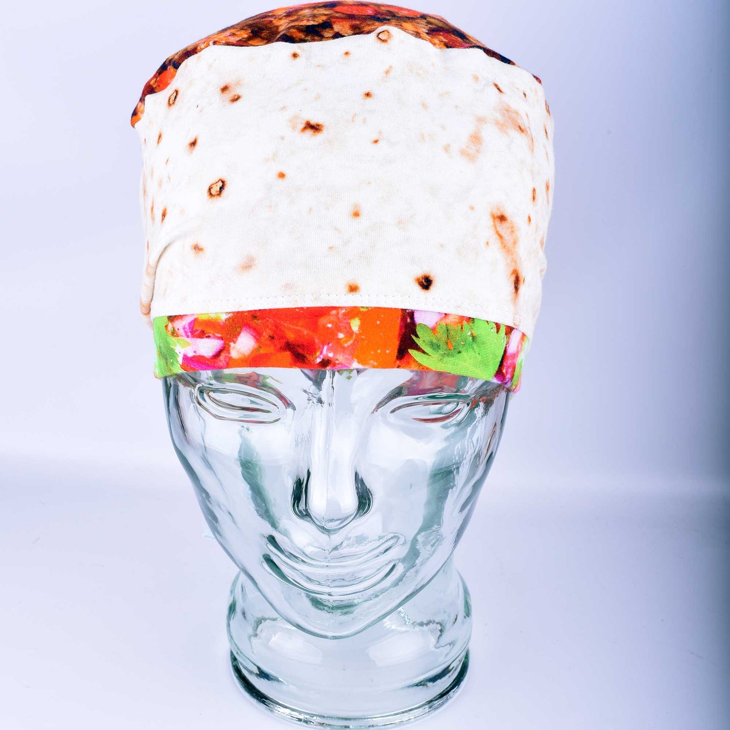 Front view of a breathable cotton scrub cap with a playful "tortilla" style print featuring illustrated burritos and tacos for healthcare professionals.