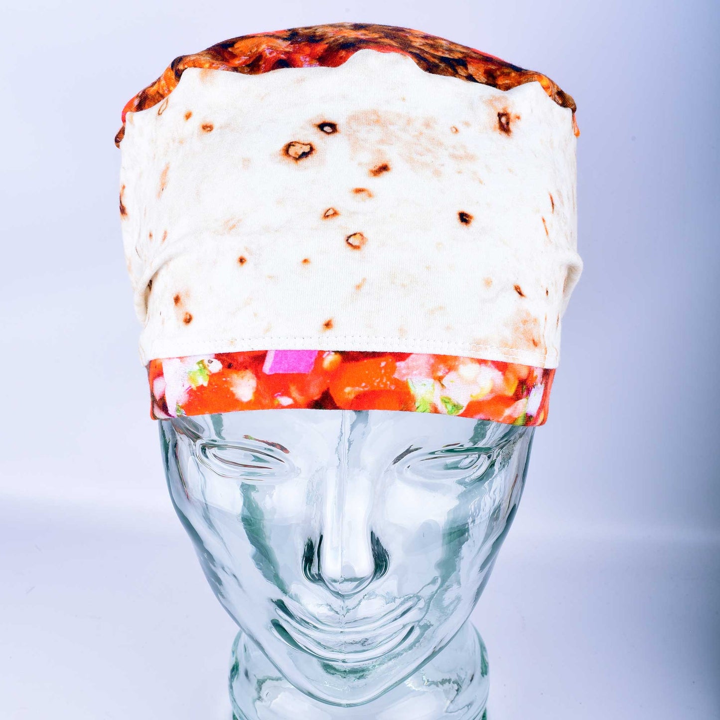 Front view of a breathable cotton scrub cap with a playful "tortilla" style print featuring illustrated burritos and tacos for healthcare professionals.