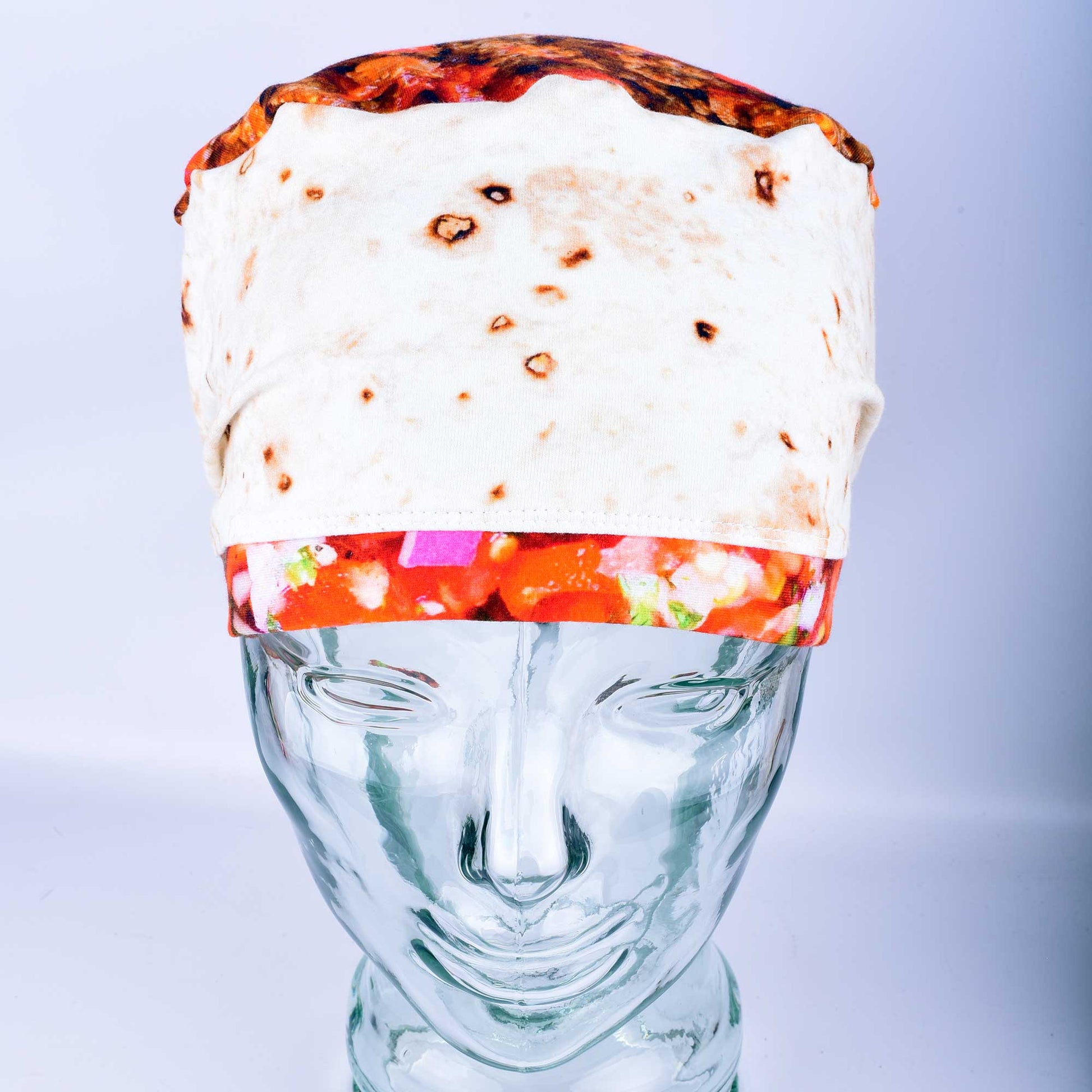 Front view of a breathable cotton scrub cap with a playful "tortilla" style print featuring illustrated burritos and tacos for healthcare professionals.