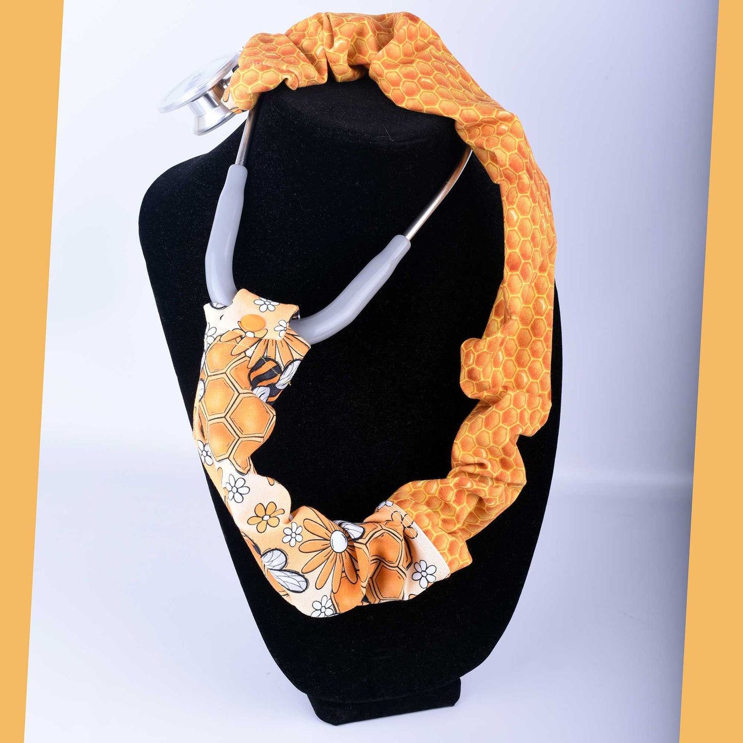 Busy Bees stethoscope cover featuring yellow honeybees and white flowers on stretchy cotton fabric.