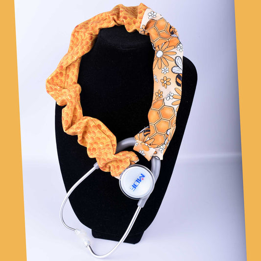 Busy Bees stethoscope cover featuring yellow honeybees and white flowers on stretchy cotton fabric.