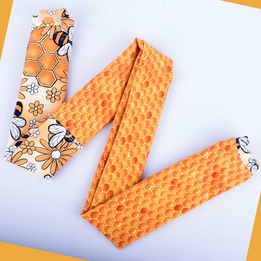 Busy Bees stethoscope cover featuring yellow honeybees and white flowers on stretchy cotton fabric.