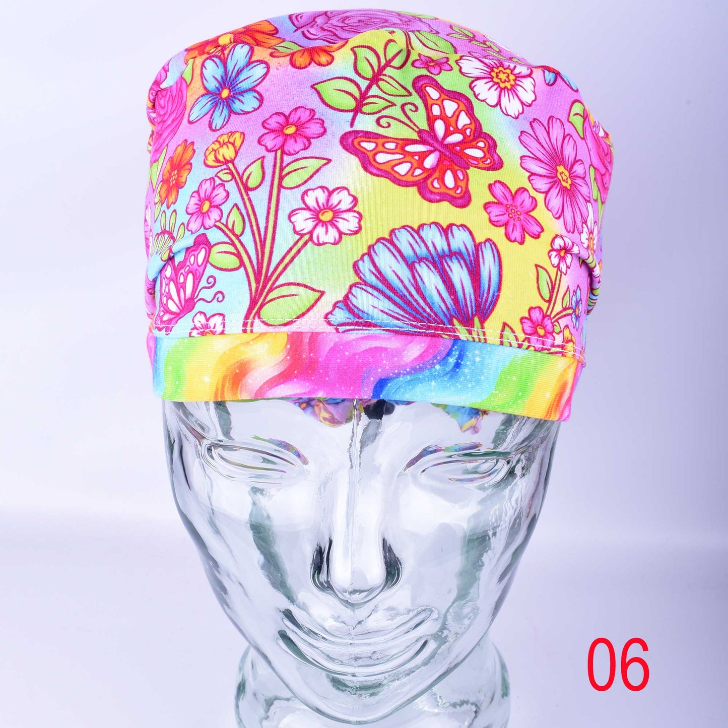 Euro style scrub cap featuring a vibrant butterfly and floral print on a white background with an adjustable toggle.
