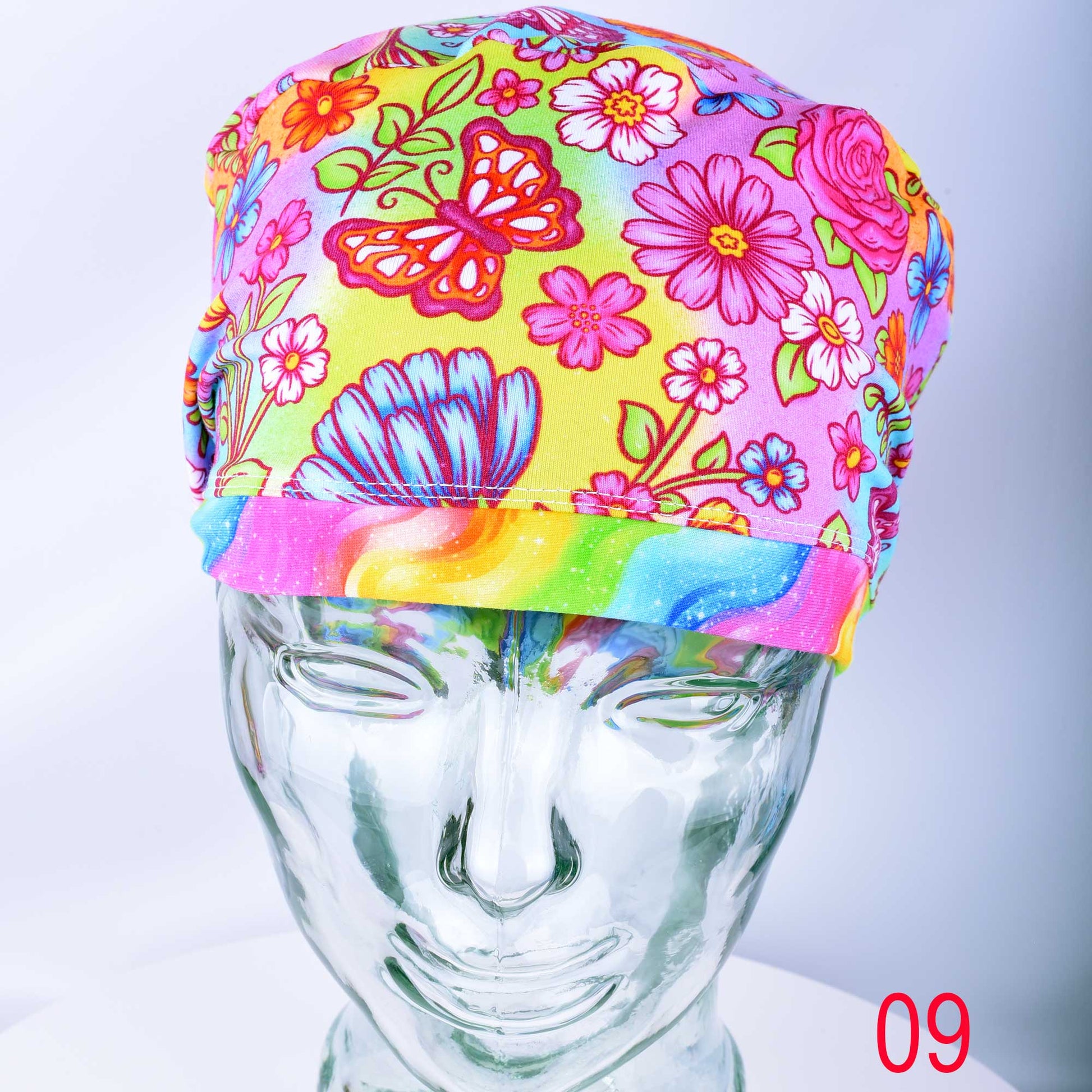 Euro style scrub cap featuring a vibrant butterfly and floral print on a white background with an adjustable toggle.