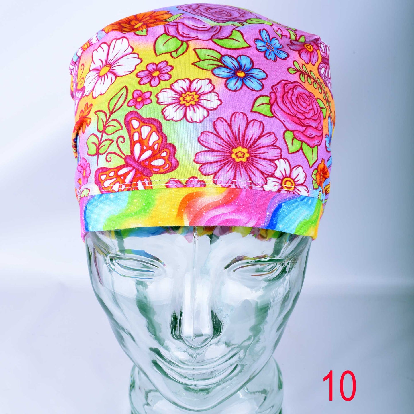 Euro style scrub cap featuring a vibrant butterfly and floral print on a colorful background with an adjustable toggle.