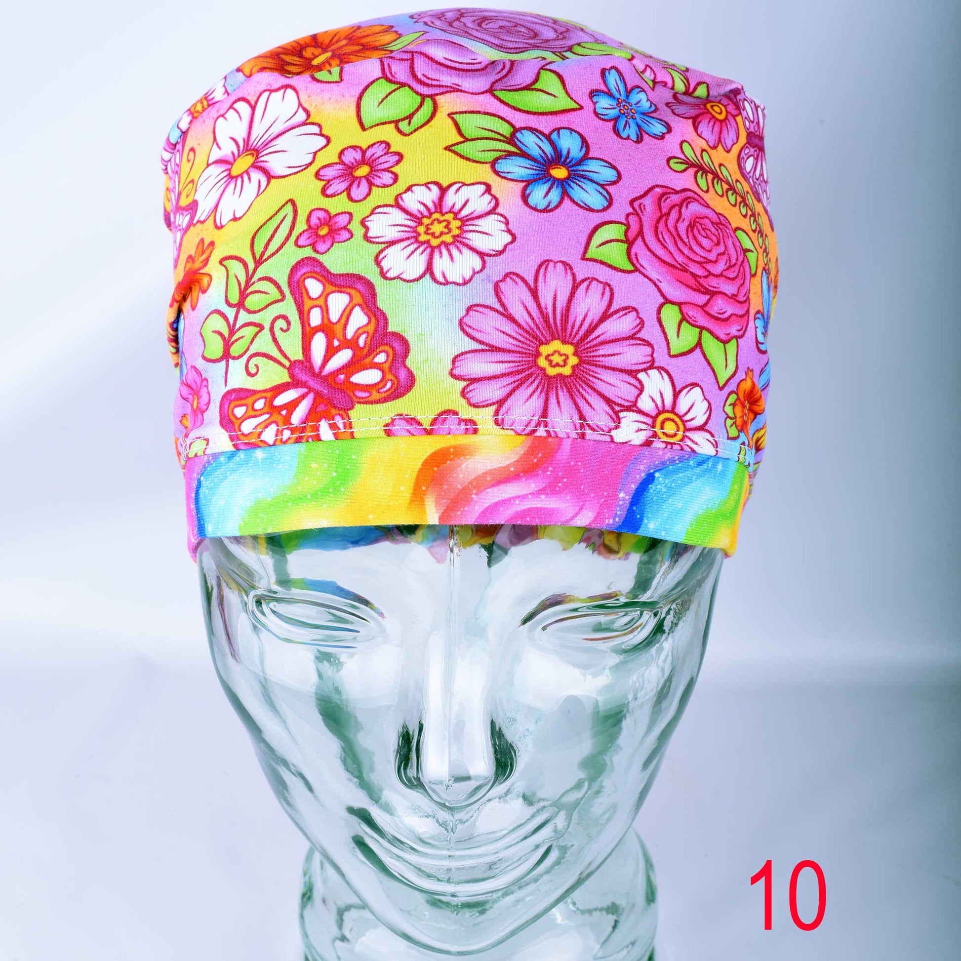 Euro style scrub cap featuring a vibrant butterfly and floral print on a colorful background with an adjustable toggle.