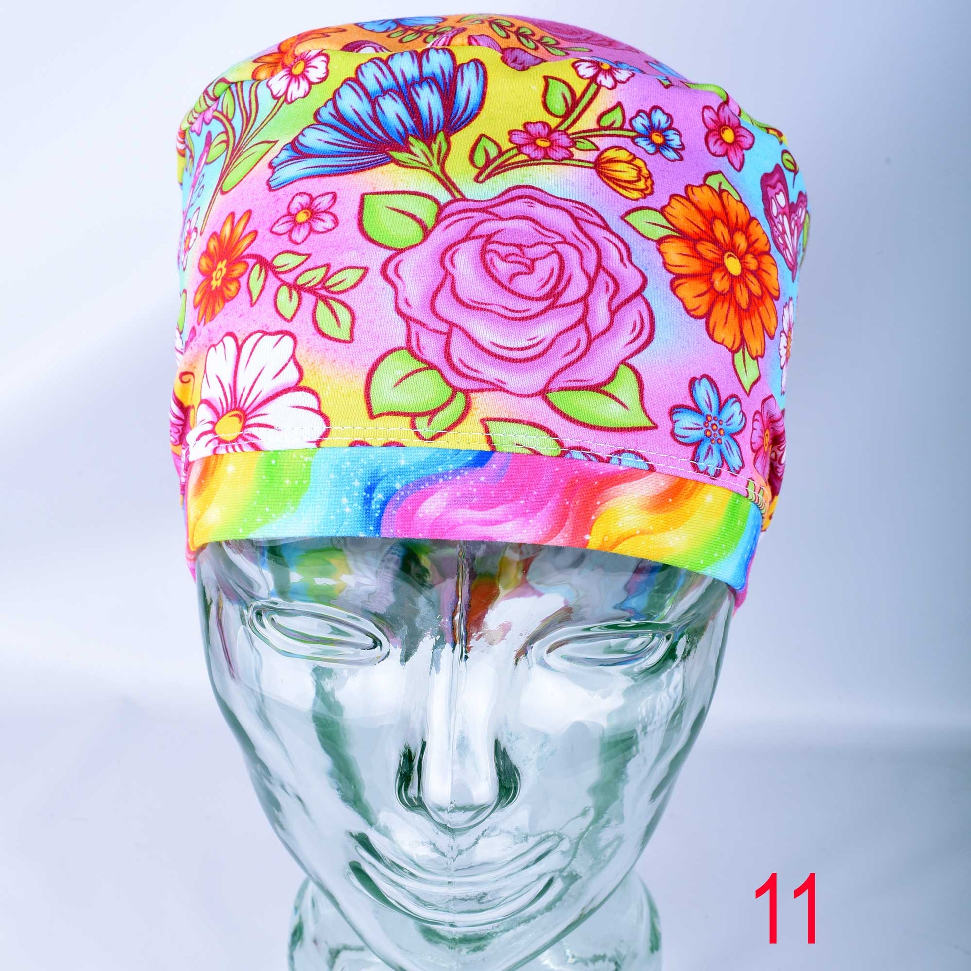 Euro style scrub cap featuring a vibrant butterfly and floral print on a colorful background with an adjustable toggle.