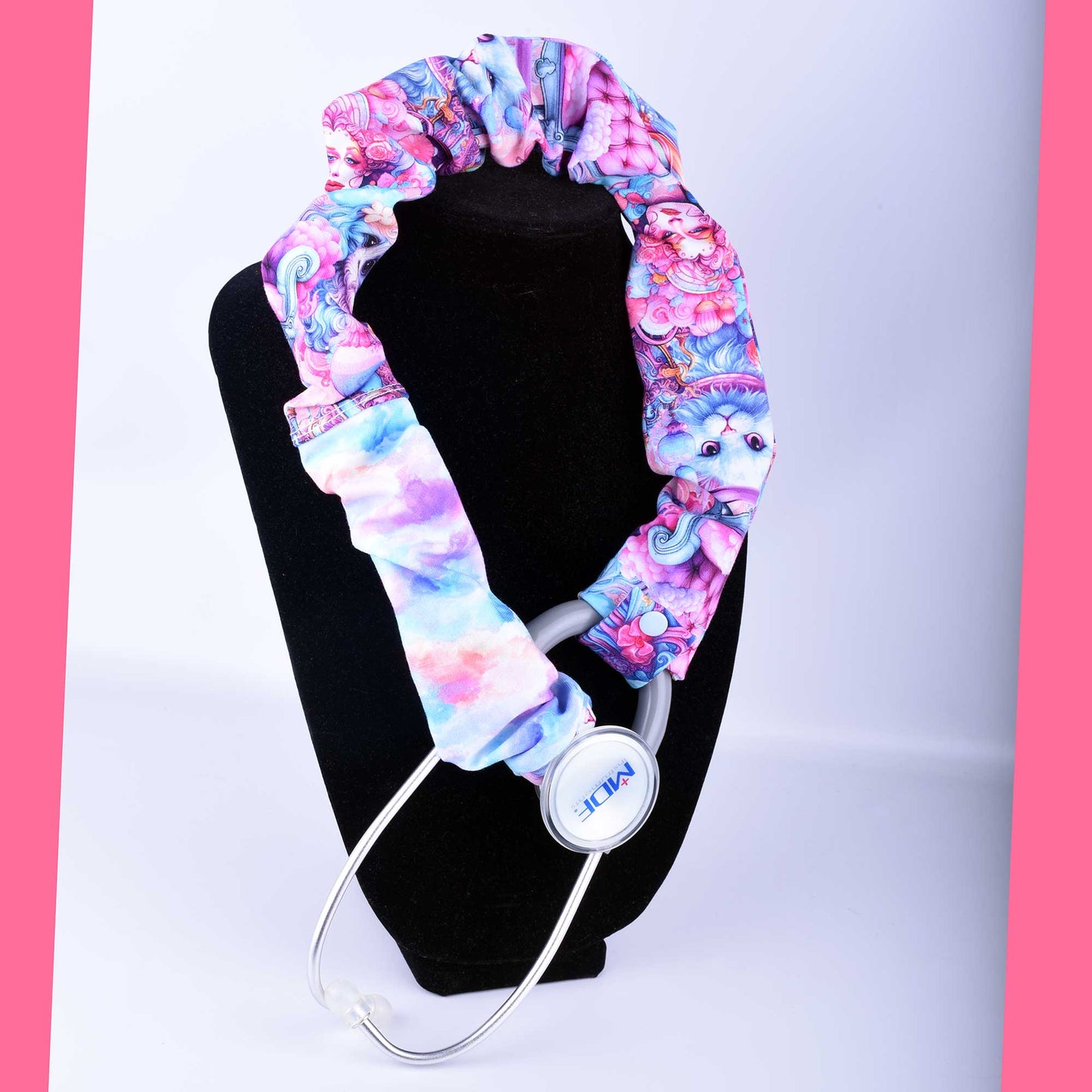 Hand-crafted pink and blue stethoscope cover. The fabric sleeve is shown fitted over a stethoscope tubing with a secure plastic snap closure.