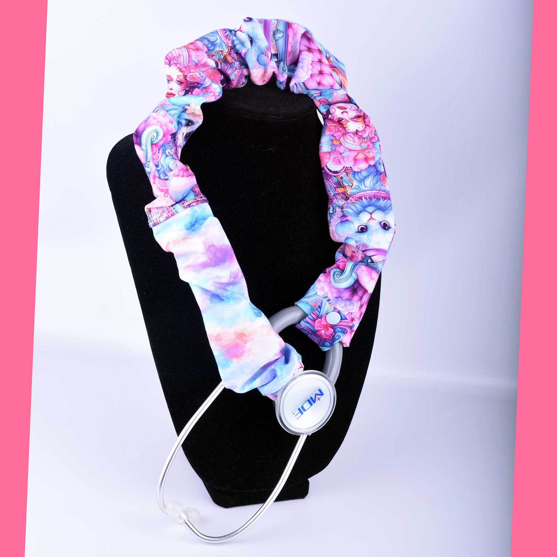Hand-crafted pink and blue stethoscope cover. The fabric sleeve is shown fitted over a stethoscope tubing with a secure plastic snap closure.