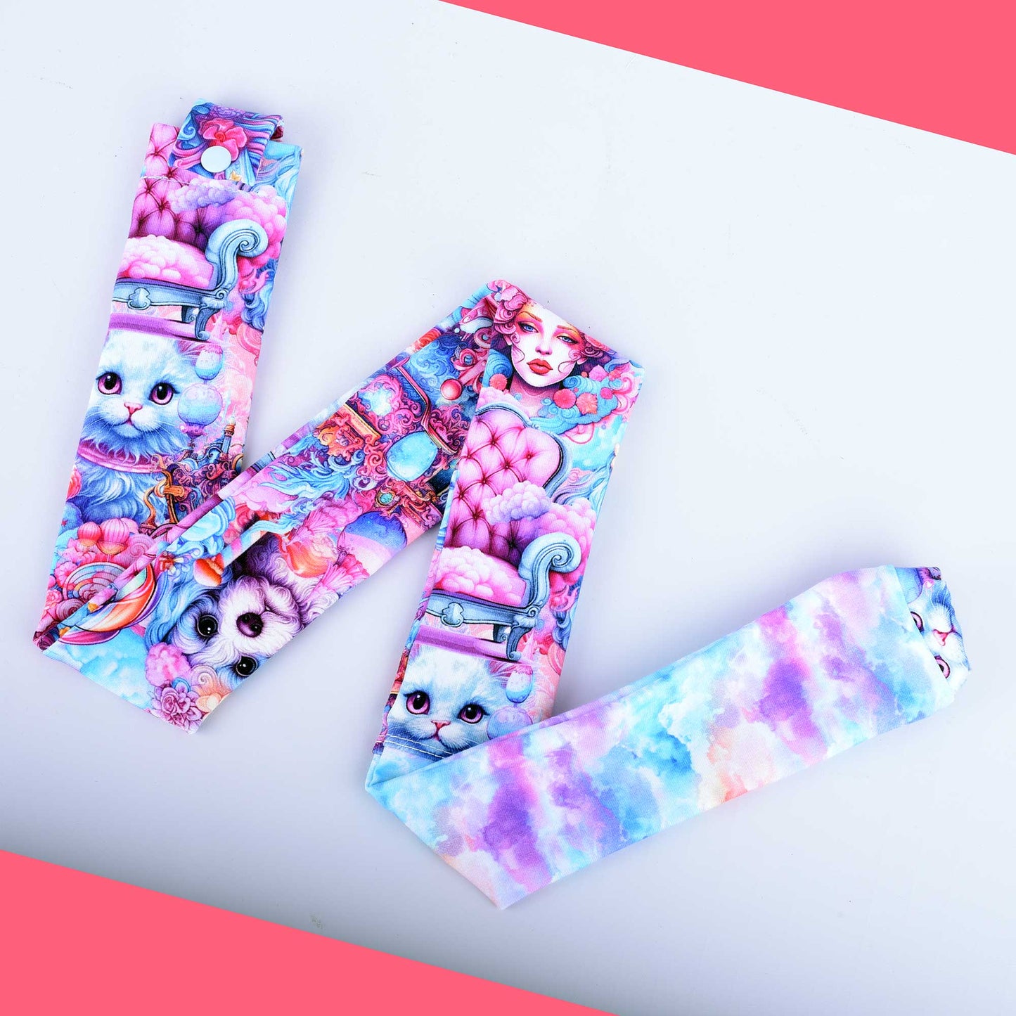 Hand-crafted pink and blue stethoscope cover featuring dogs, cats, women, and clouds. The fabric sleeve is shown fitted over a stethoscope tubing with a secure plastic snap closure.