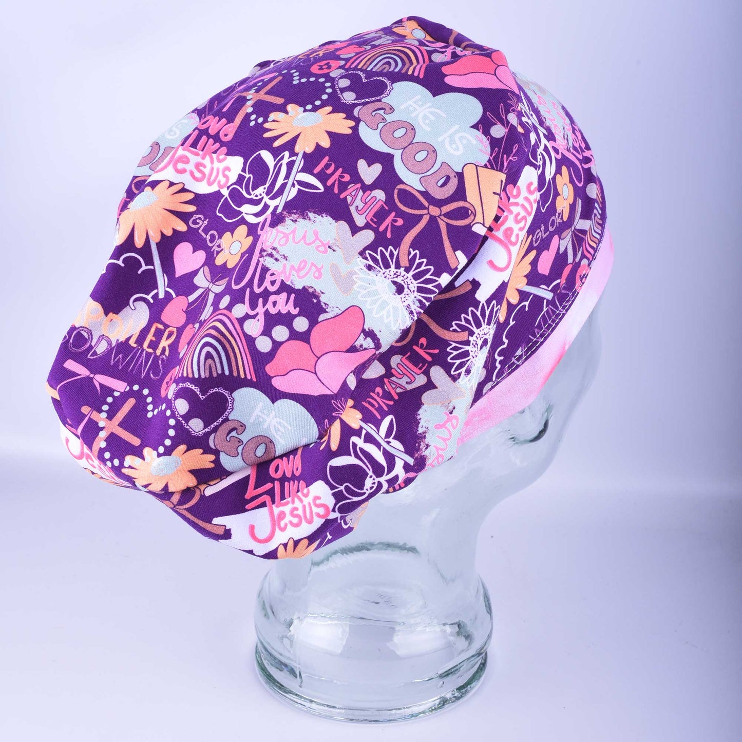 Side profile of a religious themed surgical hat , highlighting the adjustable toggle and secure fit for long hair.