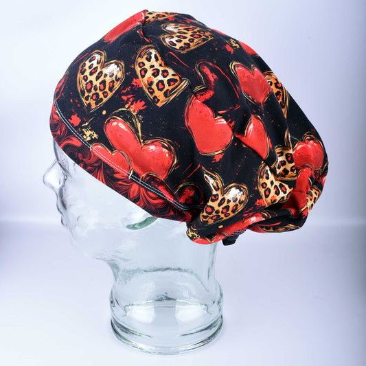 Classy Hearts Scrub Cap featuring a red and black heart pattern with cheetah print accents.