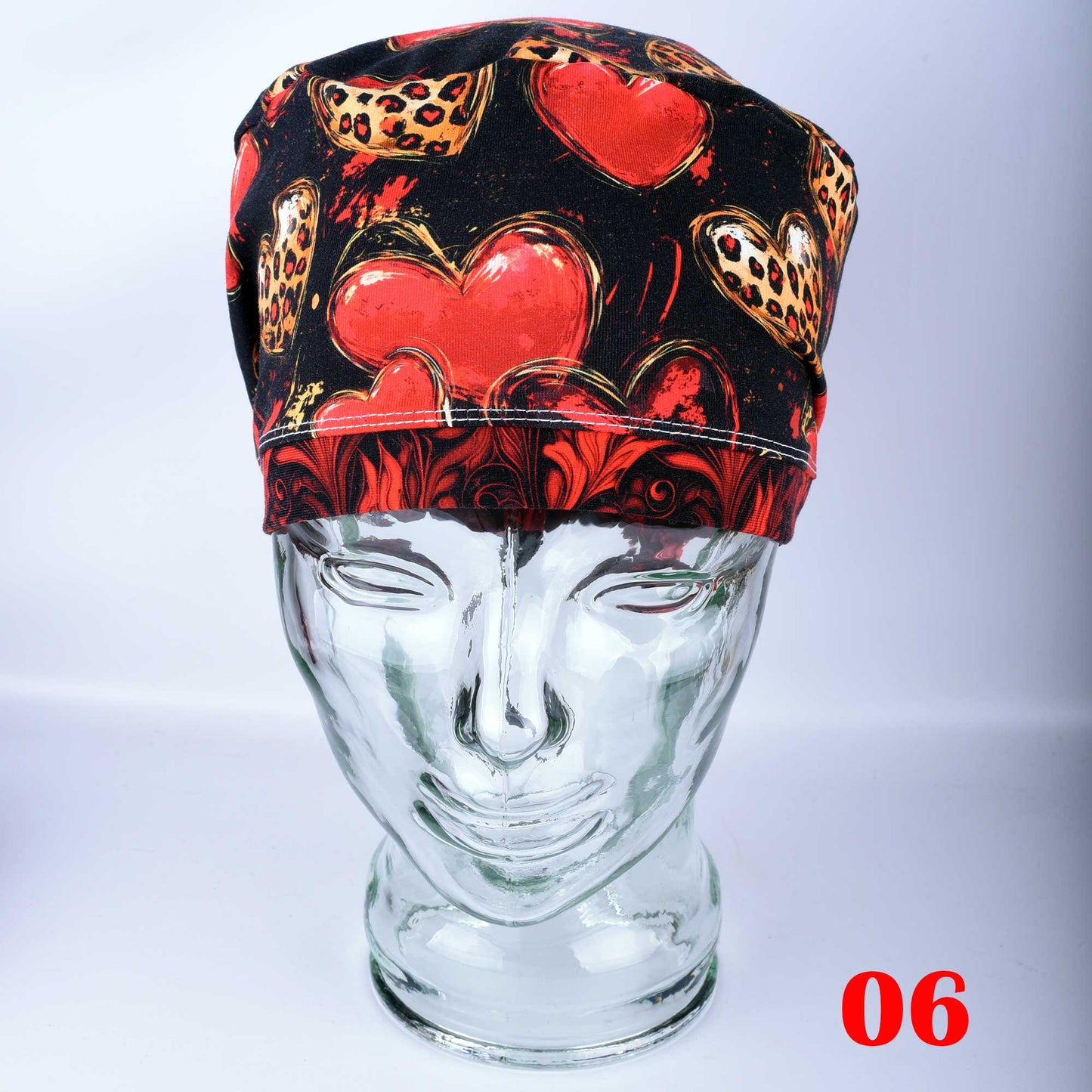 Classy Hearts Scrub Cap featuring a red and black heart pattern with cheetah print accents.