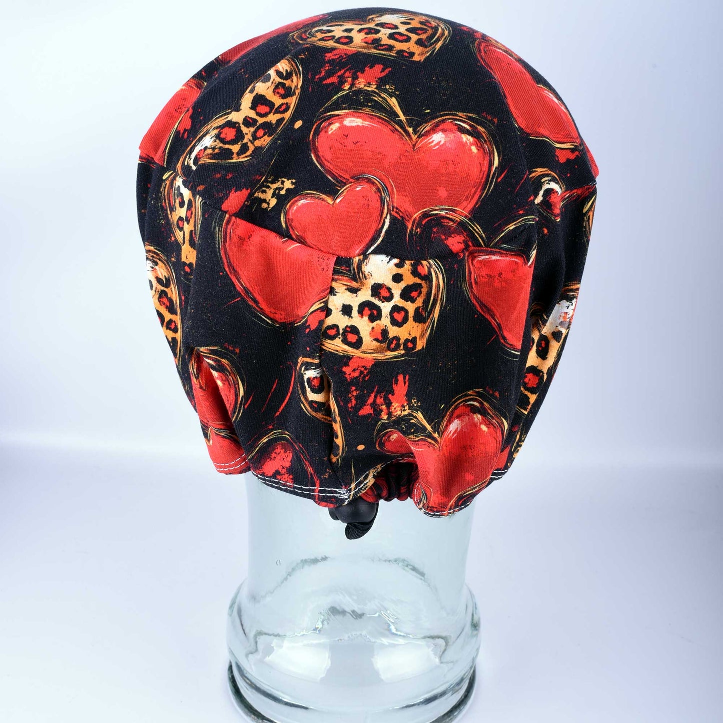 Back view of a stretchy cotton nurse hat showing the adjustable cord lock toggle for a secure, custom fit