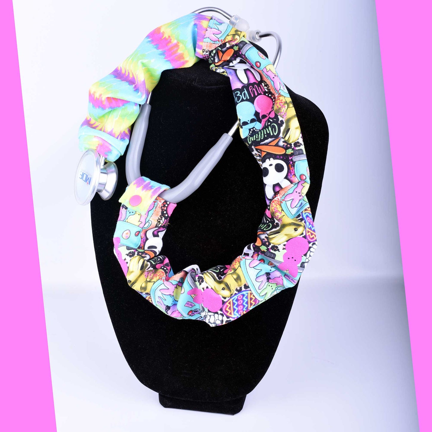 Colorful patterned stethoscope cover on a mannequin against a pink and white background