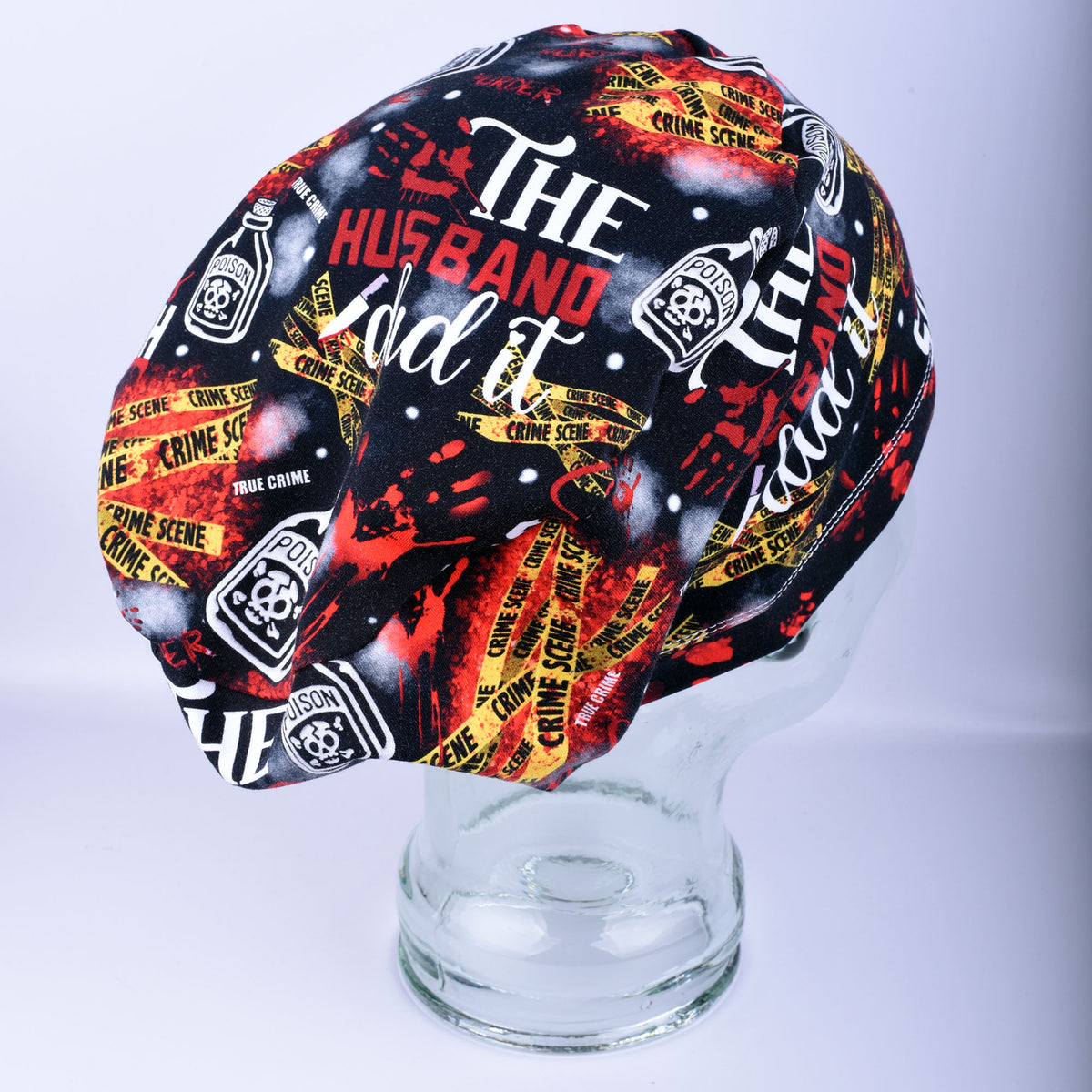 Side view of a crime scene graphic print scrub cap displaying the secure, full-coverage fit on a mannequin head.