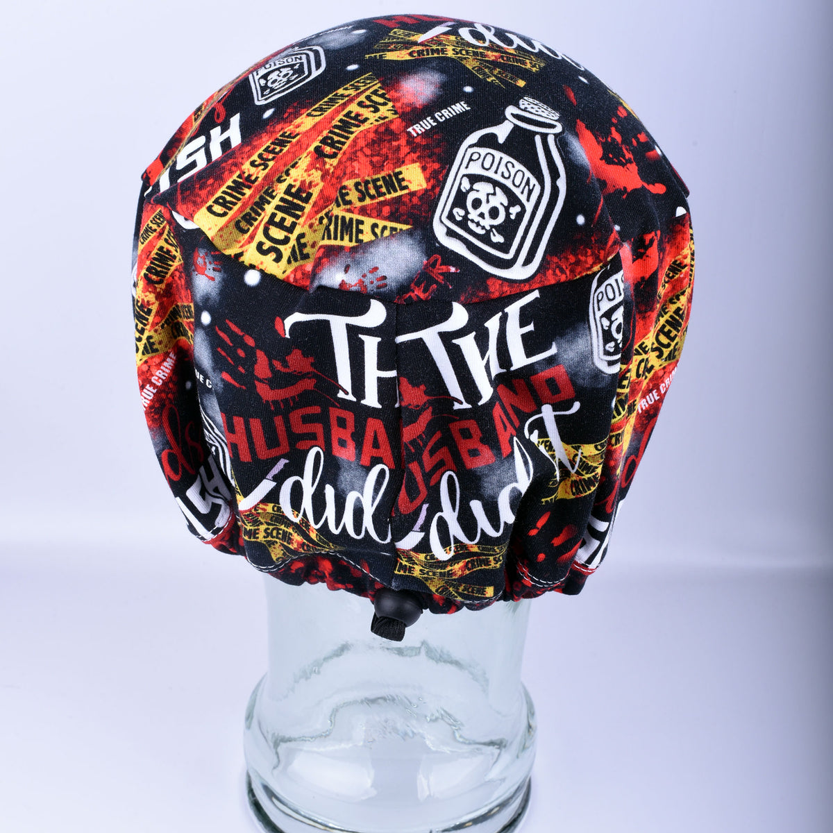 Back view of a crime scene print scrub cap showing the adjustable elastic drawstring and cord lock toggle for a custom fit.