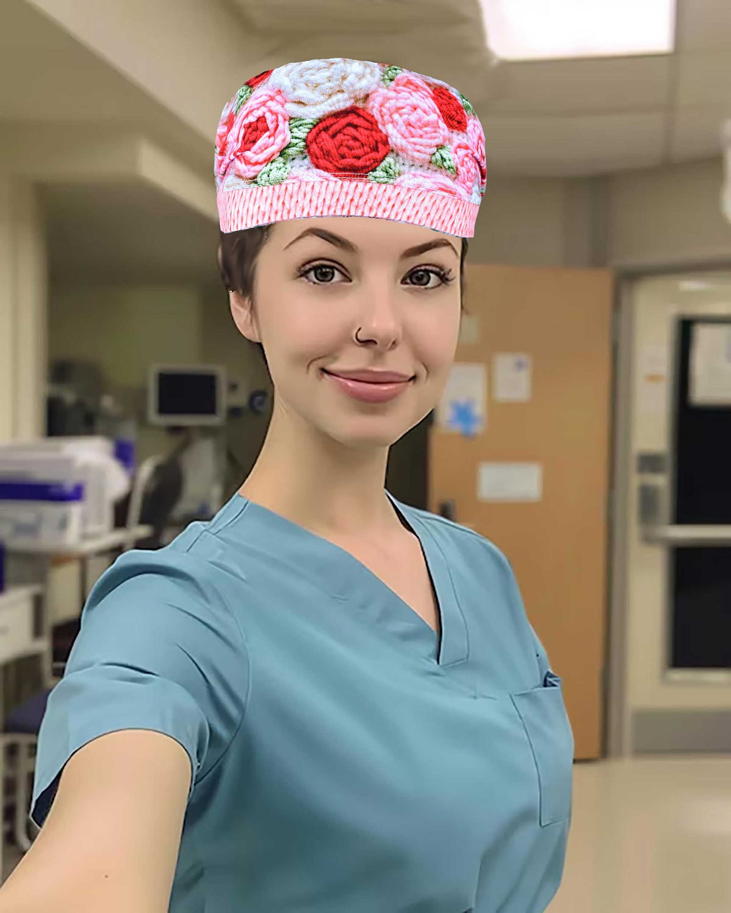 A healthcare professional wearing the Crochet Roses scrub cap in a clinical setting, showing the full-coverage fit and how it coordinates with blue medical scrubs.