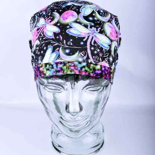 Front view of a Dragonflies Full Coverage Scrub Cap on a mannequin, featuring a vibrant purple and blue dragonfly pattern on a white background.