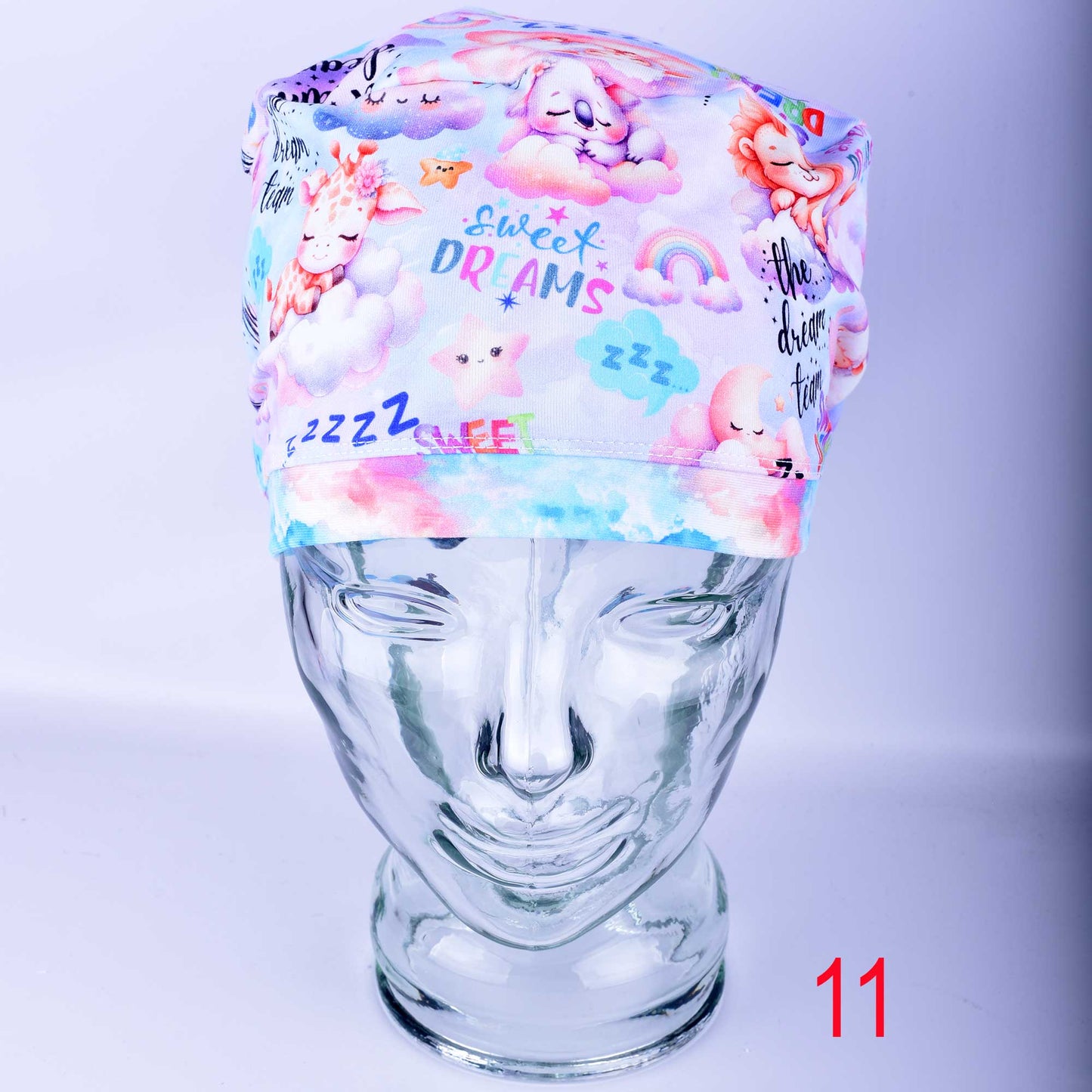 Dream Team Design 11 full coverage scrub cap for nurses and doctors, handmade with a custom-printed pastel medical art pattern.