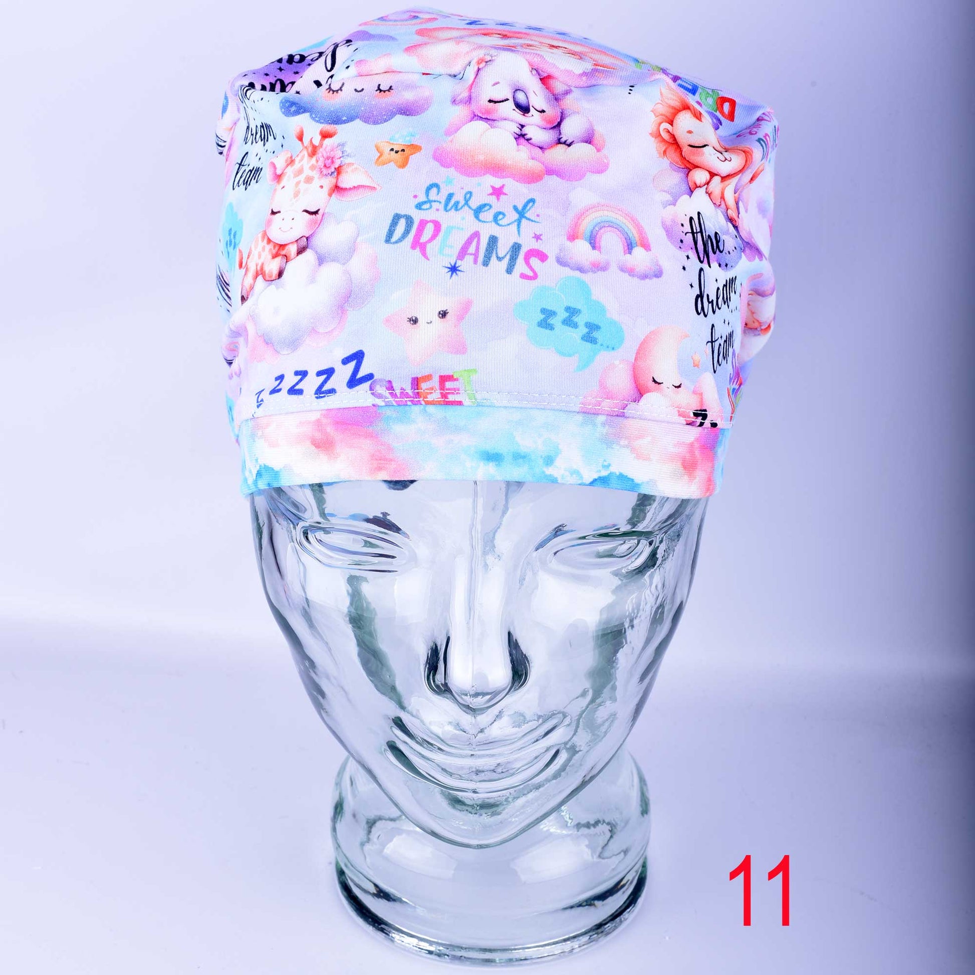 Dream Team Design 11 full coverage scrub cap for nurses and doctors, handmade with a custom-printed pastel medical art pattern.