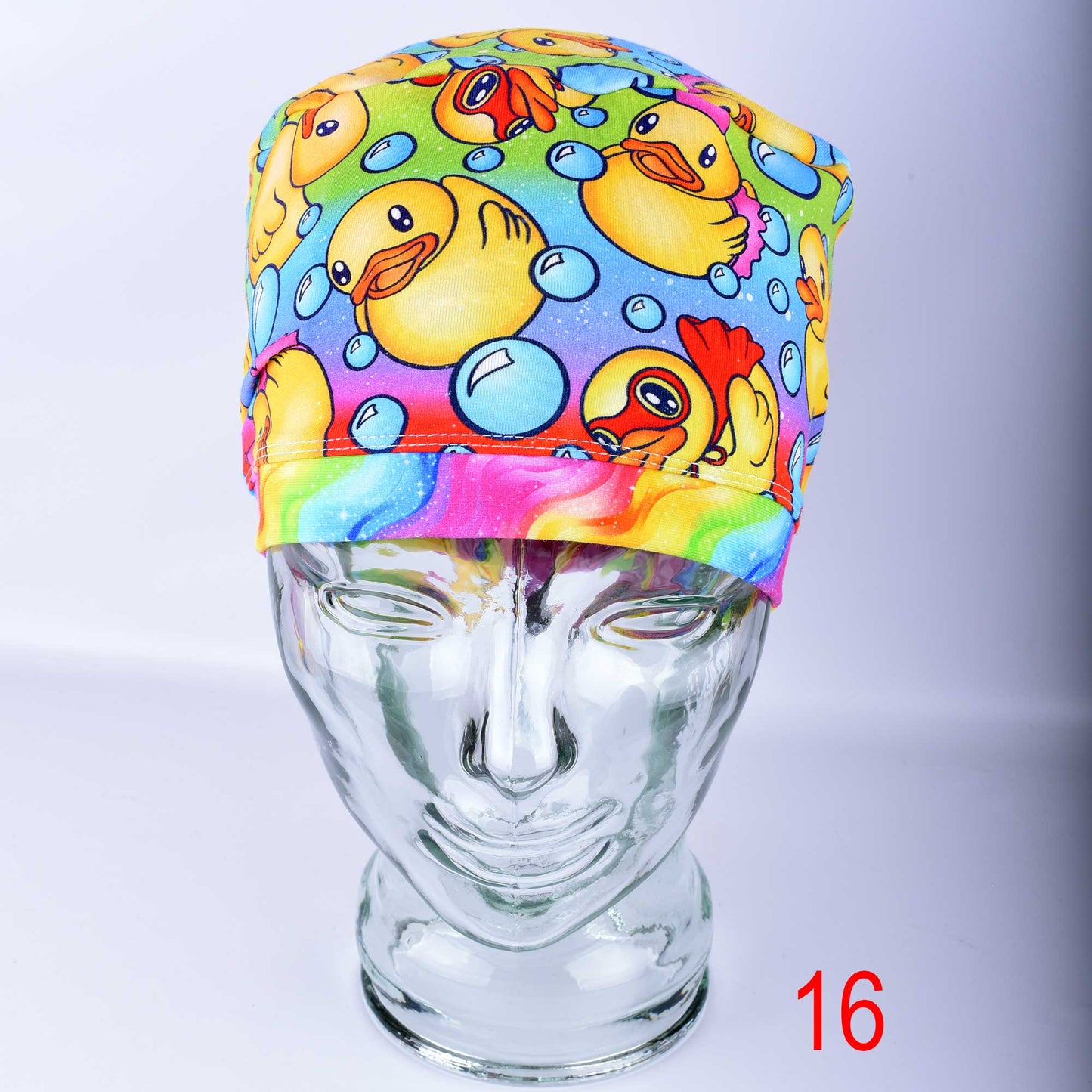 Detailed close-up of the premium, stretchy cotton-elastane fabric of a medical scrub hat, highlighting the crisp, colorful ducks and bubbles print and clean stitching.
