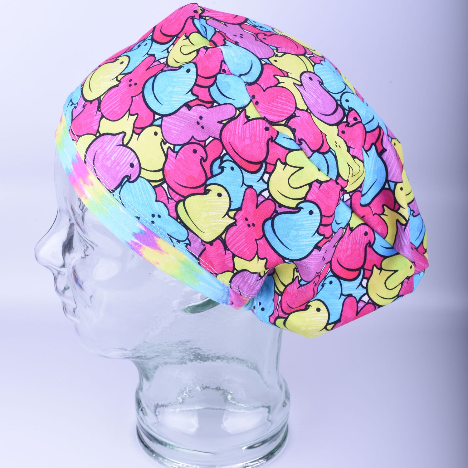 A full-coverage European-style scrub cap featuring a colorful Easter candy pattern with marshmallow chicks and bunnies.