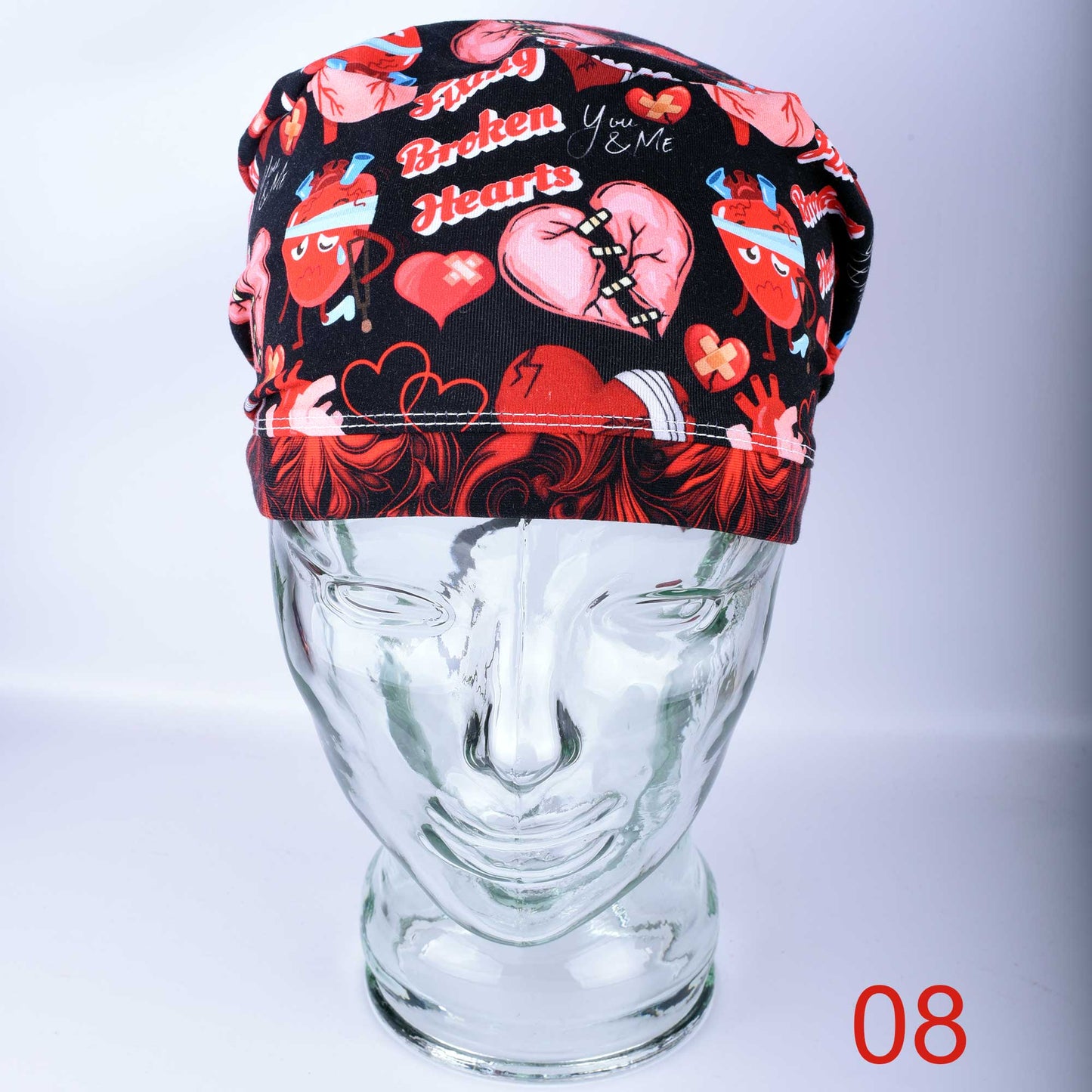 Full coverage Fixing Broken Hearts Scrub Cap with red and black heart medical pattern.