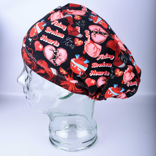 Full coverage Fixing Broken Hearts Scrub Cap with red and black heart medical pattern.