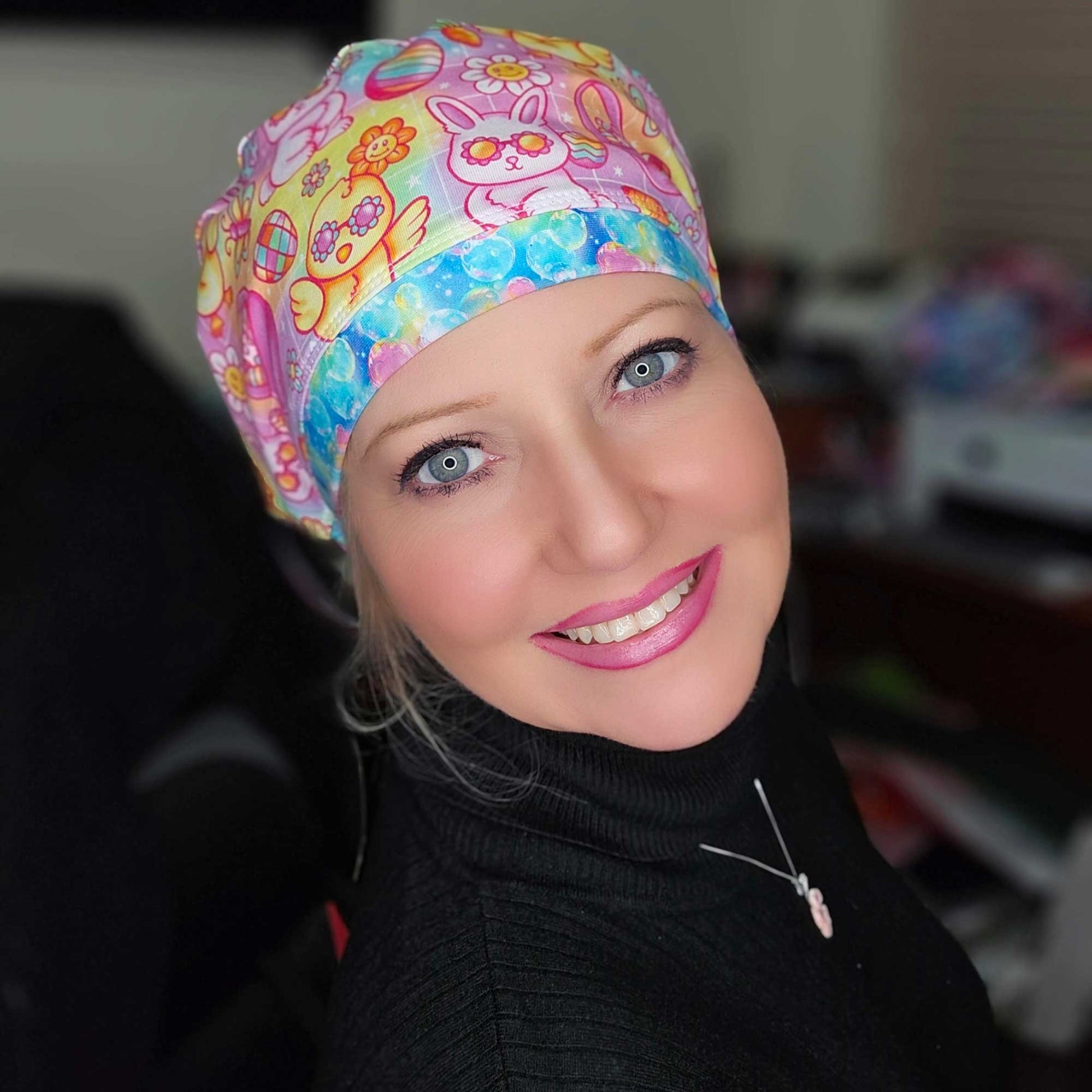 A healthcare professional smiling while wearing the Groovy Easter Euro-style scrub cap, showing how the fabric neatly secures long hair or a bun.